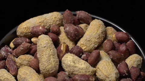 Peanuts. Mixed Peanuts in rotation. Snack closeup. black background. Stock Footage 102338543
