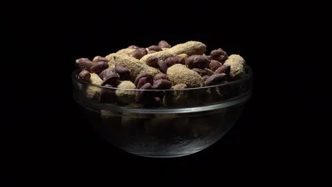 Peanuts. Mixed Peanuts in rotation. Snack closeup. black background. Stock Footage 102338588