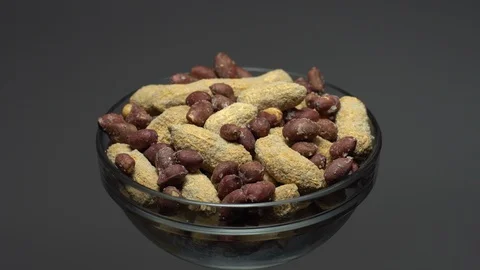 Peanuts. Mixed Peanuts in rotation. Snack closeup. Selective focus. Stock Footage 102339031