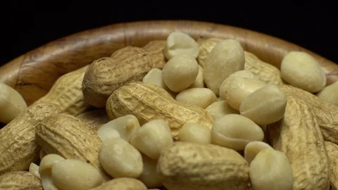 Peanuts. Mixed Peanuts in rotation. Snack closeup. black background. Stock Footage 102340652