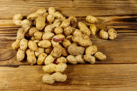 Peanuts in nutshell on a wooden table Stock Photos