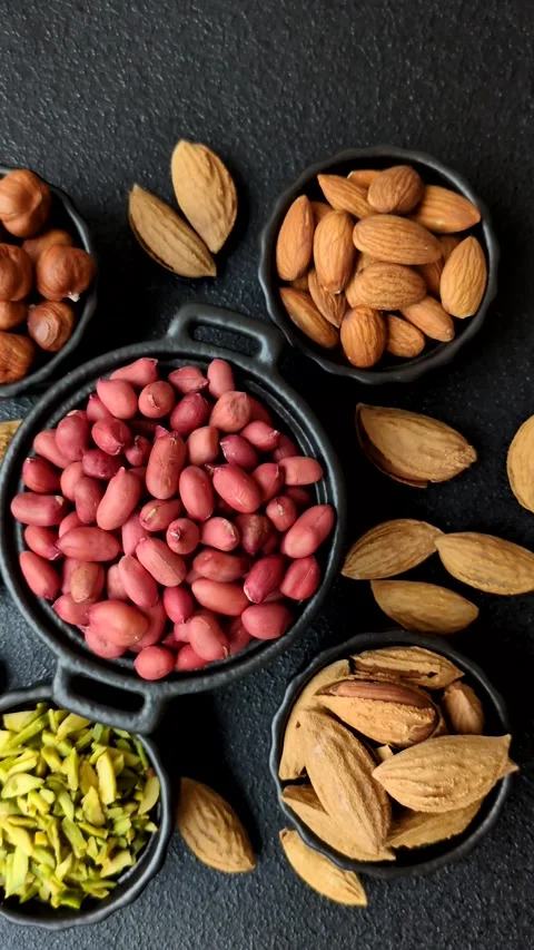 Peanuts or peeled graundnut in a bowl on a dark concrete background Stock Footage 305679227