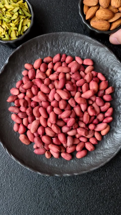 Peanuts or peeled graundnut in a bowl on a dark concrete background Stock Footage 305679241