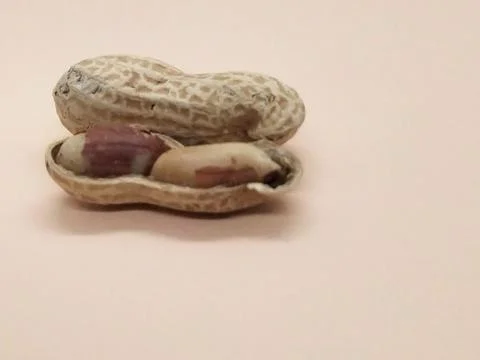 Peanuts on orange background isolate Stock Photos