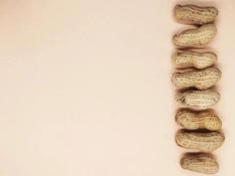 Peanuts on orange background isolate Stock Photos