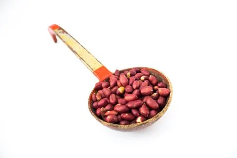 Peanuts pile. Shell Seeds into a spoon isolated on white background Stock-Fotos