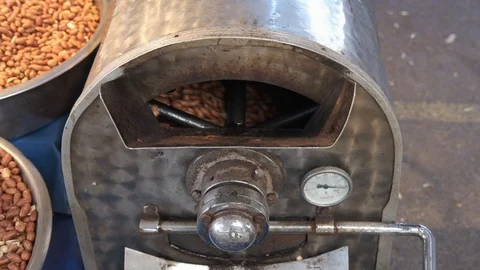 Peanuts in the roaster machine. Close-up slow-motion video. Video stock 125851091
