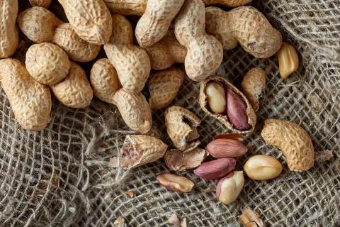 Peanuts on sackcloth background Stock Photos