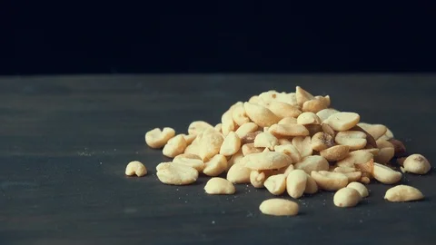 Peanuts with salt spins on a dark background Stock Footage 119581998