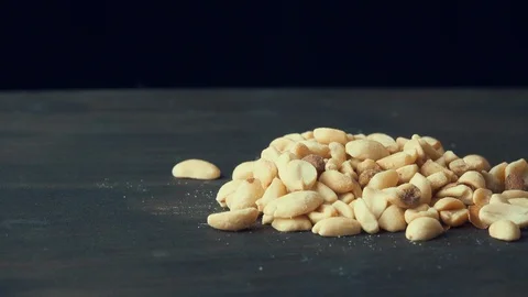 Peanuts with salt spins on a dark background Stock Footage 119582160