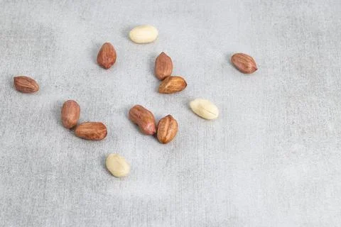 Peanuts scattered on a gray background. Top view Stock Photos
