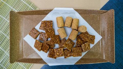 Peanuts in the shape of sweets, pacoca, cornmeal cake and peanut butter on bread Stock Photos