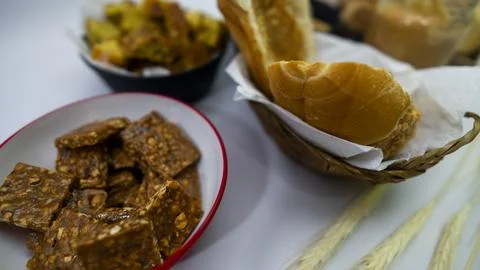 Peanuts in the shape of sweets, pacoca, cornmeal cake and peanut butter on bre Stock Photos
