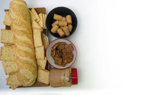 Peanuts in the shape of sweets, pacoca, cornmeal cake and peanut butter on bread Stock Photos