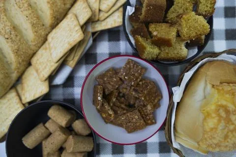 Peanuts in the shape of sweets, pacoca, cornmeal cake and peanut butter on bread Stock Photos
