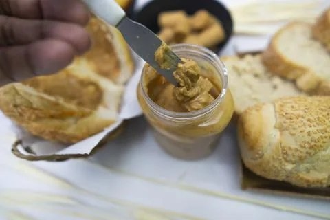 Peanuts in the shape of sweets, pacoca, cornmeal cake and peanut butter on bread Stock Photos