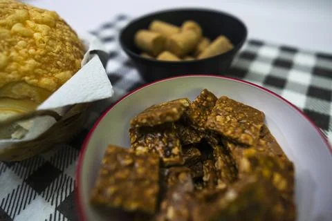 Peanuts in the shape of sweets, pacoca, cornmeal cake and peanut butter on bread Stock Photos