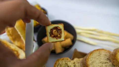 Peanuts in the shape of sweets, paçoca, cornmeal cake and peanut butter on bre 스톡 사진
