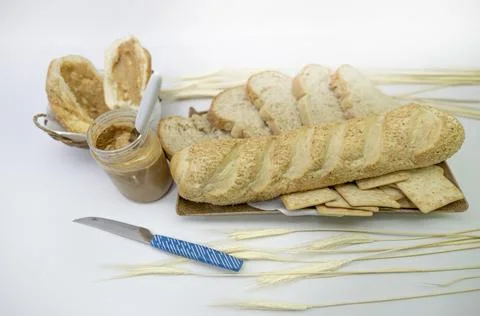 Peanuts in the shape of sweets, paoca, cornmeal cake and peanut butter on bre Stock-Fotos