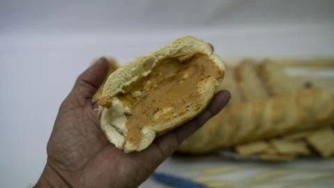 Peanuts in the shape of sweets, paoca, cornmeal cake and peanut butter on bre Stock Photos