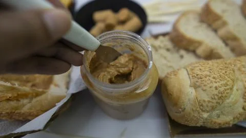 Peanuts in the shape of sweets, paoca, cornmeal cake and peanut butter on - Stock Photos