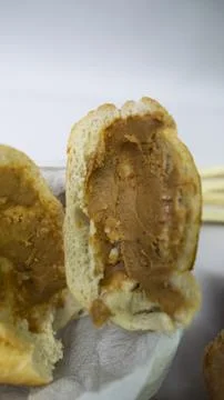 Peanuts in the shape of sweets, paoca, cornmeal cake and peanut butter on - Stock Photos
