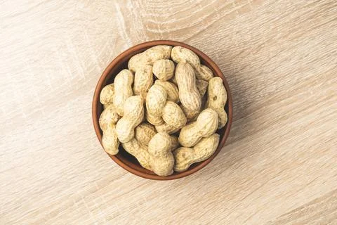 Peanuts in a shell in a clay plate Stock Photos