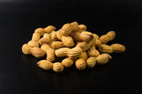 Peanuts in shell on dark background, close up Stock Photos