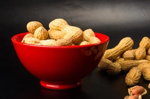 Peanuts in shell on dark background, close up Stock Photos