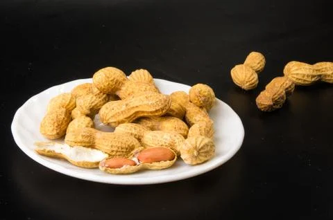 Peanuts in shell on dark background, close up Stock Photos