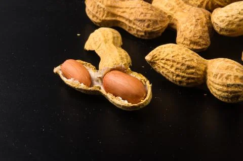 Peanuts in shell on dark background, close up Stock Photos