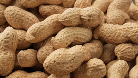 Peanuts in shell falling on black table. Roasted peanuts. Healthy nutrition Stock Footage 228951396
