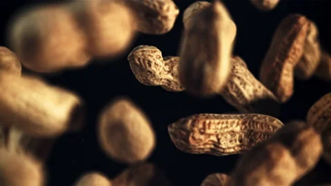 Peanuts in the shell fly up and rotate in flight. Top view. Filmed is slow Video stock 202142492