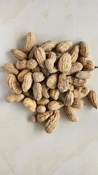 Peanuts in shell on a light background. Close-up. Stock Photos