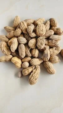 Peanuts in shell on a light background. Close-up. Stock Photos
