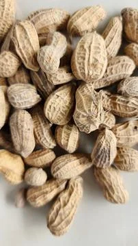 Peanuts in shell on a light background. Close-up. Stock Photos
