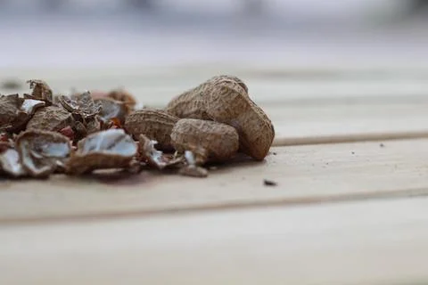 Peanuts in shell on wooden background Stock Photos
