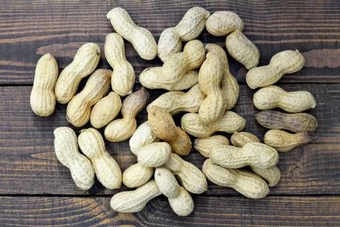Peanuts in shell on wooden background Stock Photos