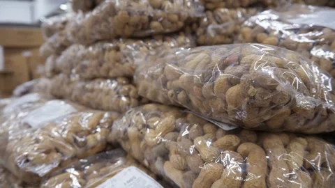 Peanuts in shells in transparent packages, lying on top of each other. A large Stock-Footage 313189754