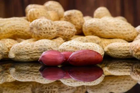 Peanuts in shells on wood background Stock Photos