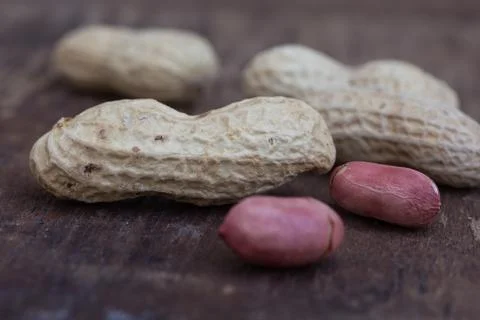 Peanuts in shells on wood background Stock Photos