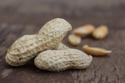 Peanuts in shells on wood background Stock Photos
