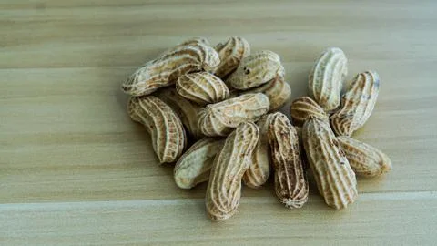 Peanuts in shells on wood background Stock Photos