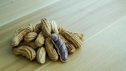 Peanuts in shells on wood background Stock Photos