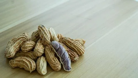 Peanuts in shells on wood background Stock Photos