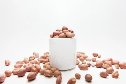 Peanuts in small cups isolated on white background Stock Photos
