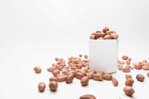 Peanuts in small cups isolated on white background Stock Photos