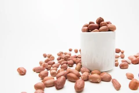 Peanuts in small cups isolated on white background Stock Photos