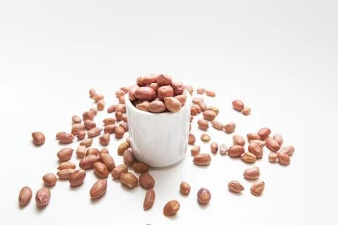 Peanuts in small cups isolated on white background Stock Photos