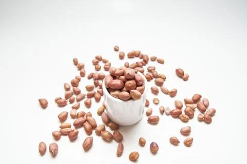 Peanuts in small cups isolated on white background Stock Photos